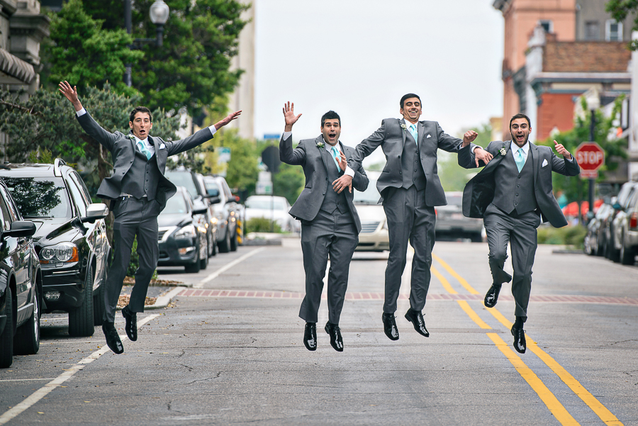 4 groomsmen jumping in the air